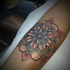 a woman's arm with a flower tattoo on it