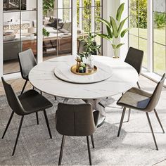 a dining room table with chairs and a vase on top of it in front of large windows