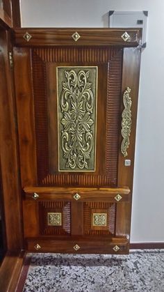 an ornate wooden paneled door with gold accents