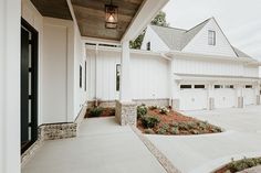 a white house with two garages on the side