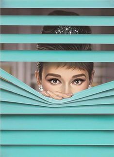 a woman peeking out from behind the blinds