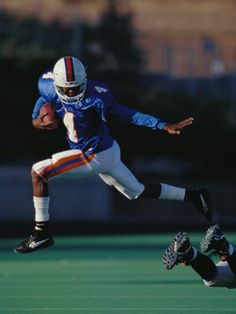 a football player is running with the ball