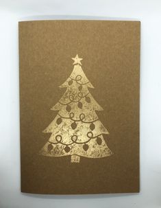 a brown card with a white christmas tree on it