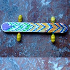 a skateboard with yellow wheels is on the ground