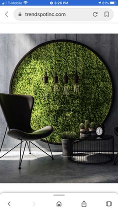 an image of a green wall with plants on it and some lights hanging from the ceiling