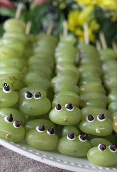 grapes with googly eyes and the words caterpillar grape kabobs on them