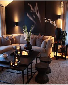 a living room filled with lots of furniture and candles on top of the coffee table