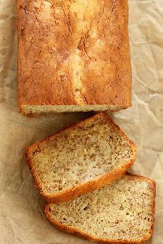 two loaves of bread sitting on top of wax paper