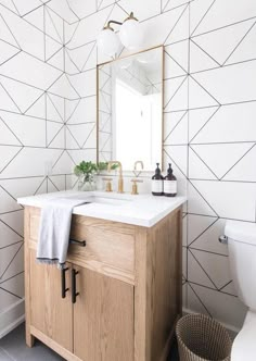 a bathroom vanity with a mirror, sink and towel on the counter in front of it