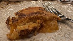 a piece of pie sitting on top of a white plate with a fork next to it