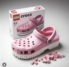 a pair of pink crocs shoes sitting next to a box of lego blocks