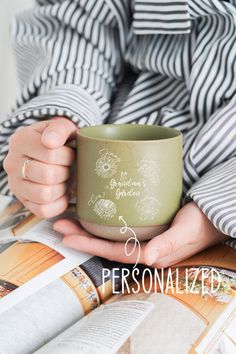 a person holding a cup with the words personalized on it in front of them