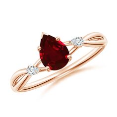 a rose gold ring with a pear shaped red garnetia and two white diamonds