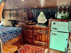 an old fashioned kitchen and bed in a trailer