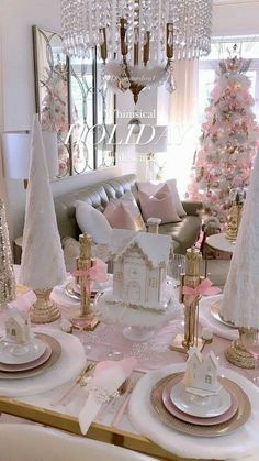 a table set for christmas with pink and white decorations