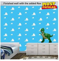 a child's bedroom with a dinosaur wallpaper