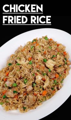 chicken fried rice with peas and carrots on a white plate