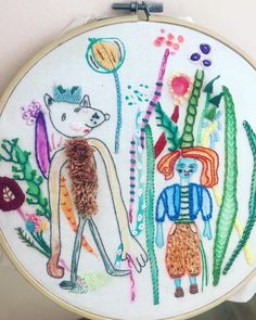 an embroidery project with two people and plants