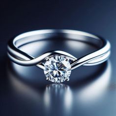 a white gold ring with a diamond in the center on a dark background, close up