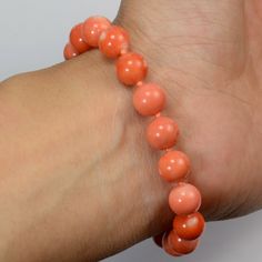 "Thank you for coming in! Classic 14K solid gold bracelet with Japanese Momo undyed sphere bead, no dye, 100% natural momo color and patterns! 7\" long with 14k diamond clasp, 17.83 grams~ You'll get the bracelet you see! SIZE of coral: Appr. 8.5mm-9mm Weight: 17.83 grams MATERIAL: 14k Solid gold, Natural coral, Diamond" Elegant Coral Beaded Bracelets, Handmade Coral Bracelet With Round Beads, Hand-strung Coral Bracelets With Round Beads, Coral Stretch Bracelet With Round Beads As Gift, Coral Stretch Bracelet With Round Beads, Elegant Orange Bracelet, Orange Bracelets With 8mm Round Beads, Solid Gold Bracelet, Natural Coral