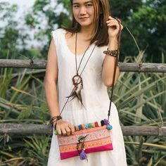 "This beautiful crossbody bag is made with an amazing piece of fabric woven by the HMONG hill tribes of Lanna Country (Northern Thailand). It decorate with multi pom pom. It features a zippered opening area, inside zippered pocket and removable strap. It's a great bag for carrying anything. We buy materials from Hmong market and we design and sew by hand. Some of the bags we modify to improve the product. The Hmong tribes live in the North of Thailand and have origins from the Tibetan area of Ch Festival Crossbody Mobile Phone Bag, Bohemian Style Clutch Shoulder Bag For Travel, Bohemian Clutch Shoulder Bag For Travel, Bohemian Woven Clutch Shoulder Bag, Bohemian Crossbody Mobile Phone Bag, Bohemian Clutch Shoulder Bag With Adjustable Strap, Festival Shoulder Bag For Mobile Phone, Woven Pouch Shoulder Bag For Festivals, Bohemian Everyday Use Pouch