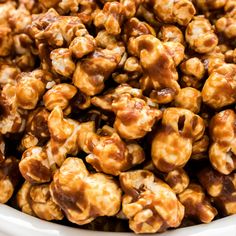 caramel popcorn nuts in a white bowl