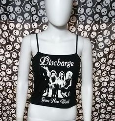 This is a black Discharge crop tank top with spaghetti straps. This has a Discharge image screen printed on the front. 57% cotton/ 38% polyester/ 5% SpandexThese are handmade screenprinted and slightly vary from the photo. Please feel free to email me any questions. Thanks for looking. Fitted Alternative Style Tank Top With Graphic Print, Black Band Merch Crop Top For Summer, Black Cotton Band Merch Crop Top, Fitted Band Merch Crop Top For Concert, Band Merch Crop Top For Concert, Fitted Cotton Alternative Style Crop Top, Summer Band Merch Crop Top, Fitted Graphic Print Tank Top For Concerts, Cotton Crop Top For Concert