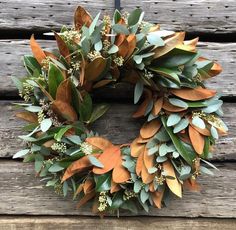 a wreath is hanging on the side of a wooden wall