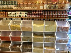 the shelves are filled with different kinds of spices and condiments for sale in a store