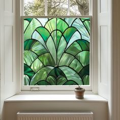 a potted plant sitting on top of a window sill next to a window