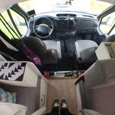 the interior of a vehicle with someone's feet on the floor