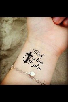 a person with a cross tattoo on their wrist