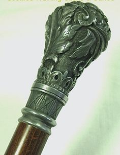 an ornate silver and wood pen on a white background with the caption scotties walking sticks & canes