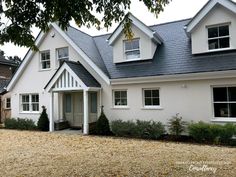 a white house with black roof and windows