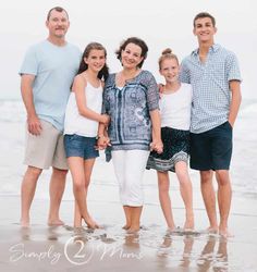 a family poses for a photo on the beach