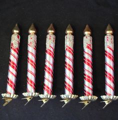 five red and white candles lined up in a row