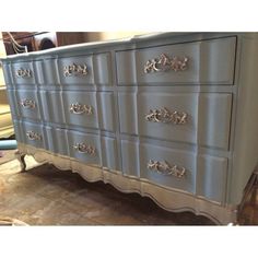 an old dresser is painted blue and silver