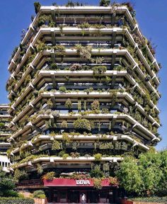 a tall building with plants growing on it's sides