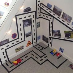 an indoor play area with toys and pictures on the wall, along with some stairs