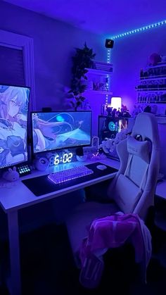 two computer monitors sitting on top of a desk in front of a purple wall with lights