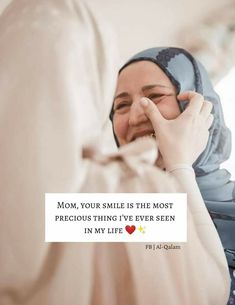 a woman wearing a hijab smiling and holding her hand up to her face