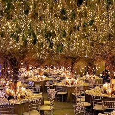 a large room with tables and chairs covered in lights