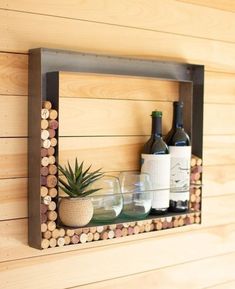 a wooden shelf with wine bottles and glasses on it