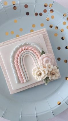 a close up of a cake on a plate with confetti and gold dots