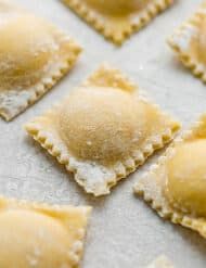 small ravioli shells covered in powdered sugar