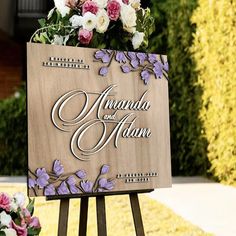 a wooden sign with flowers on it