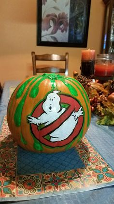 a painted pumpkin sitting on top of a table