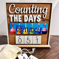 a wooden sign that says counting the days until birthday