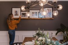 a woman standing in front of a dining room table