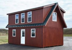 a red house with white windows and a black roof